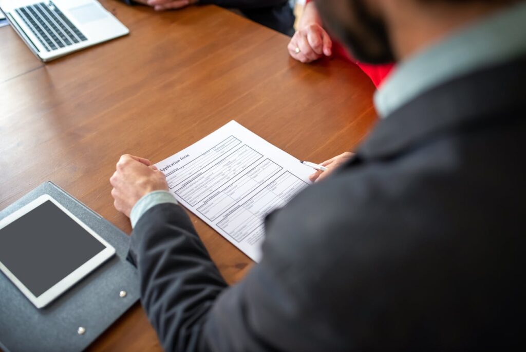 A man in a suit is looking down at an application for DSCR loans for Airbnb and short-term rentals. 