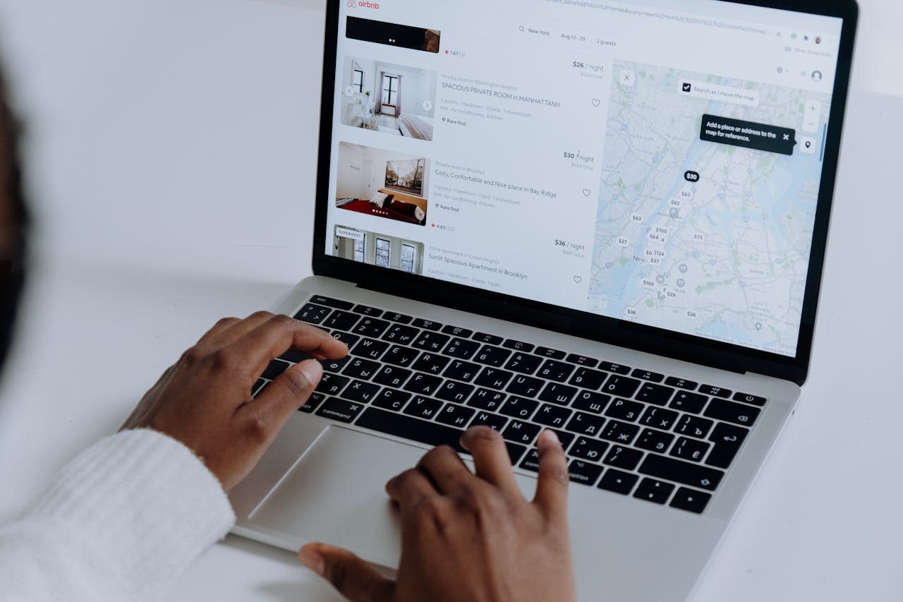 A woman is on her laptop booking a vacation rental that was financed with DSCR loans for Airbnb and short-term rentals.