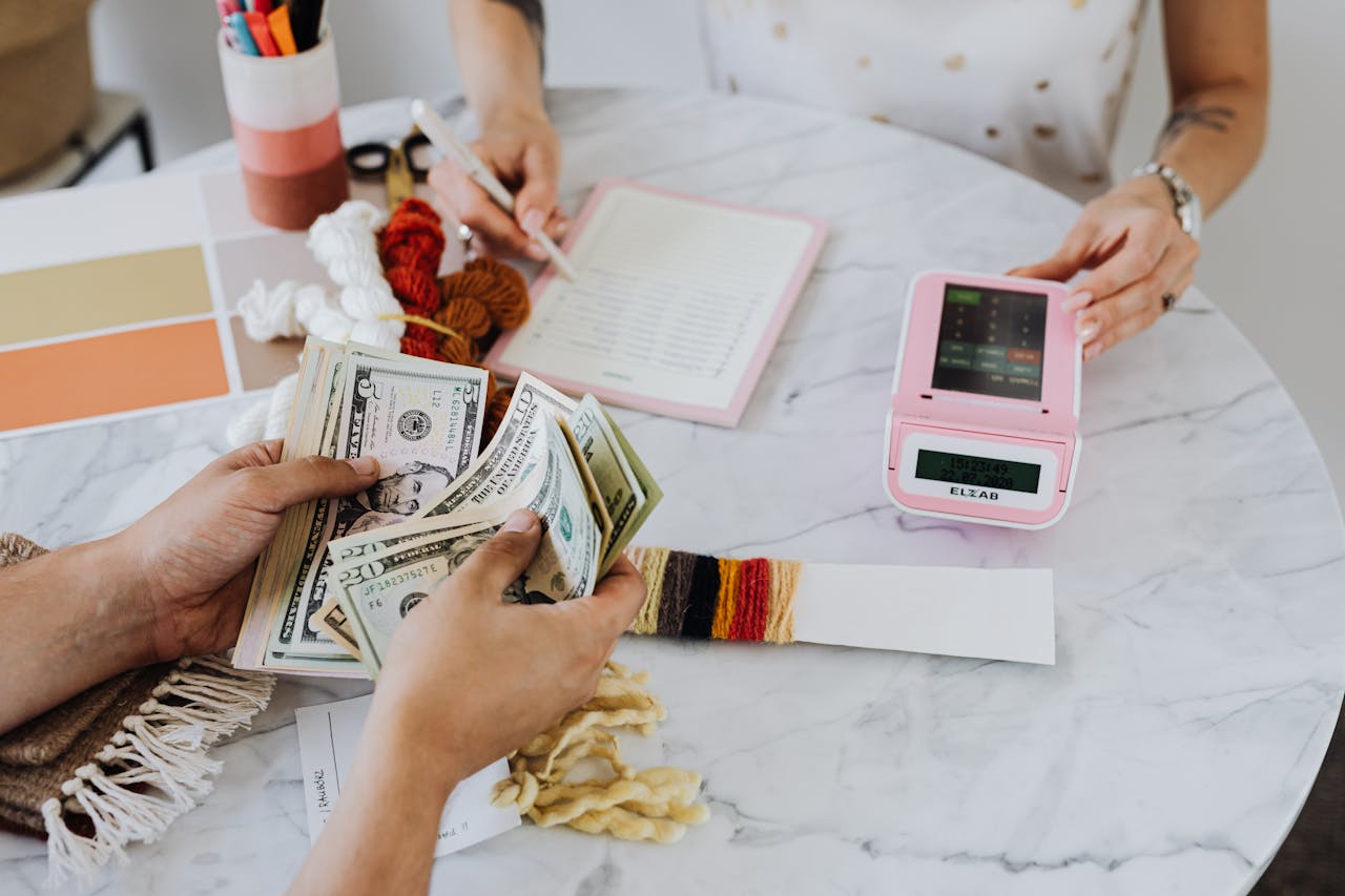 A small business owner is calculating their revenue on a table, which is a factor that's considered for P&L loans.