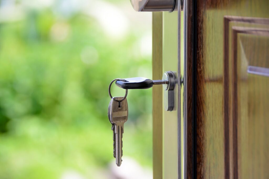 A key unlocking a door, just like how a cash-out refinance for investment properties allows you to unlock equity.