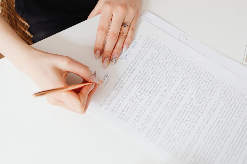 A woman is signing cash-out refinance documents on closing day. 