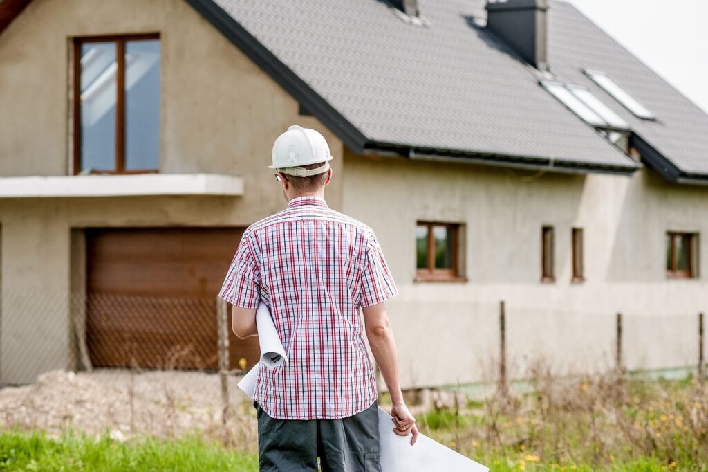 An architect is walking toward a house that was purchased with DSCR loans for fix-and-flip projects. 