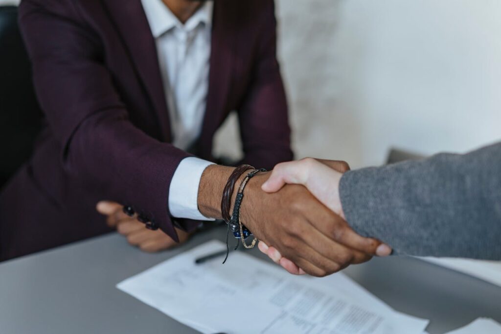 A loan officer shaking a client's hand while closing the deal on a construction loan Texas.