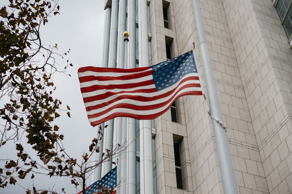 An American flag flying outside of a bank building. 