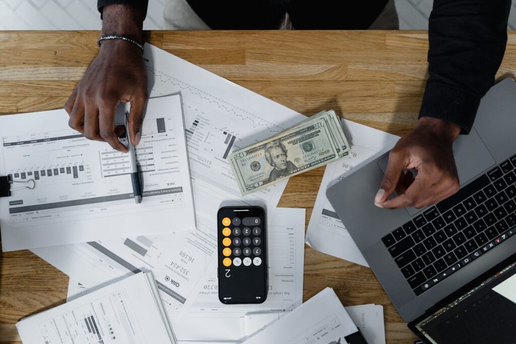 A top-down view of a man sorting out his finances and budgeting to see if a home equity loan makes sense for him. 