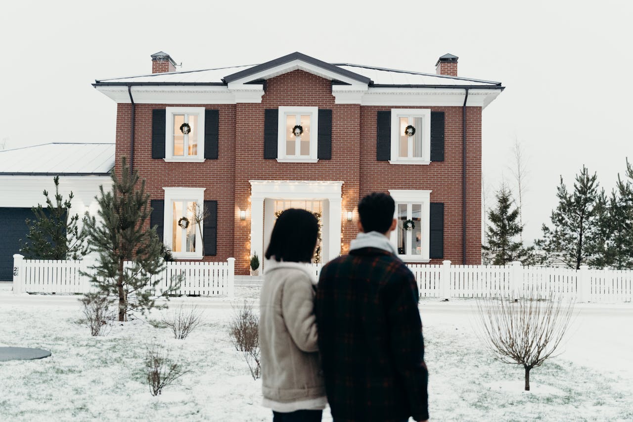 A couple standing outside of their house that has enough equity for a bank statement home equity loan.