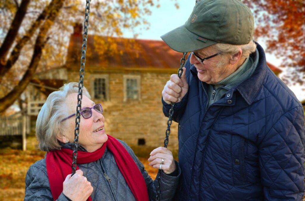 A retired couple is smiling and looking at each other, knowing they have options with home loans for unemployed borrowers that will consider their retirement accounts as income. 