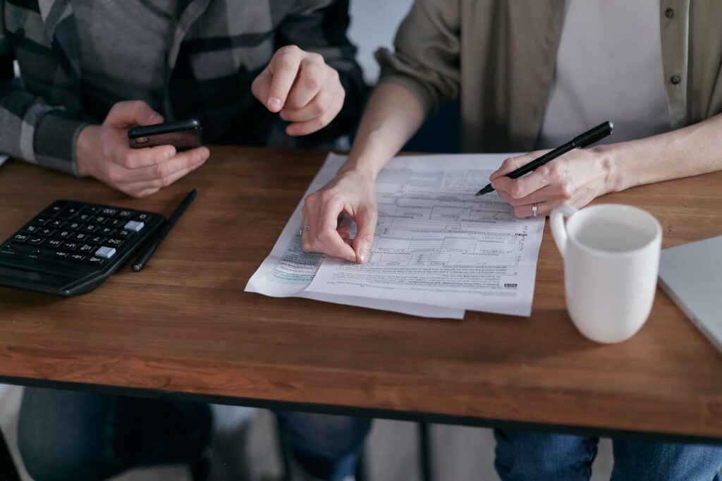 A couple is reviewing their finances to see how to get a loan without a job. 