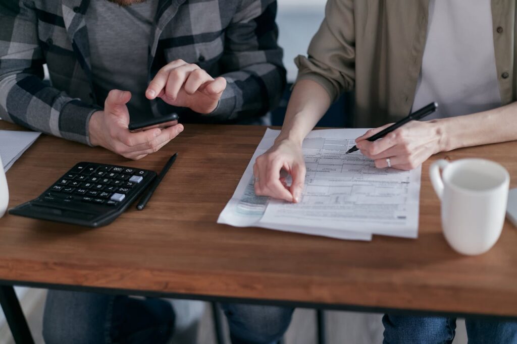 A couple is going through their financial documents to determine if they'd be eligible for a loan with a non-traditional mortgage lender. 