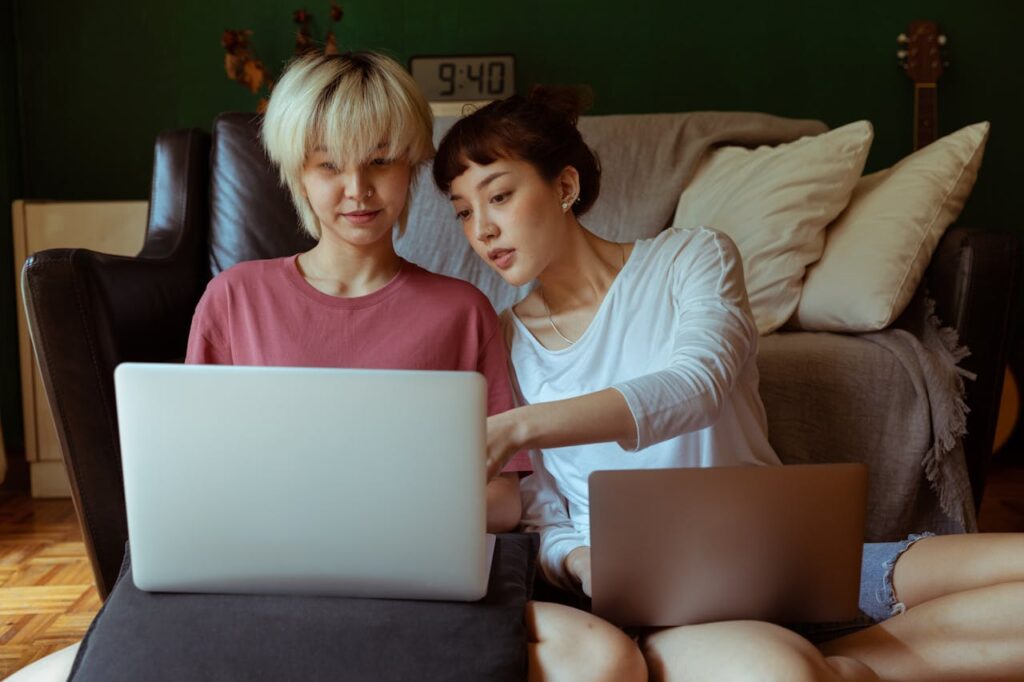 After reading our tips on where to get a mortgage, a couple is comparing interest rates, terms, and fees on their laptops together.